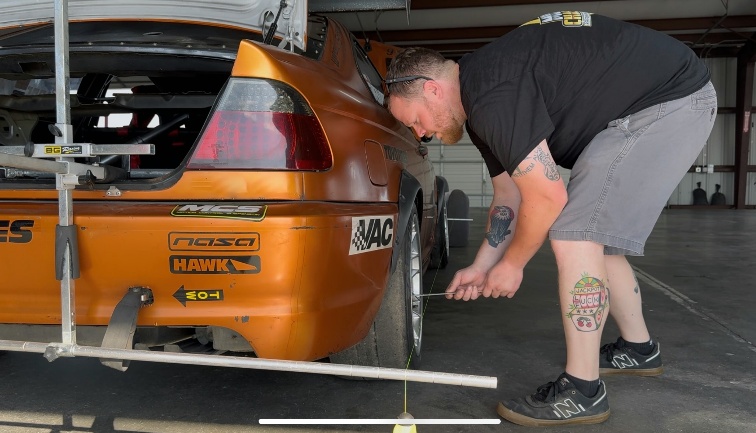 Dan McGuigan performing a mobile performance alignment on a race car for Mobile Chassisworx