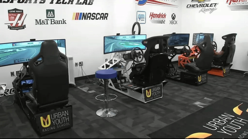 Urban Youth Racing School simulator room with racing rigs and screens